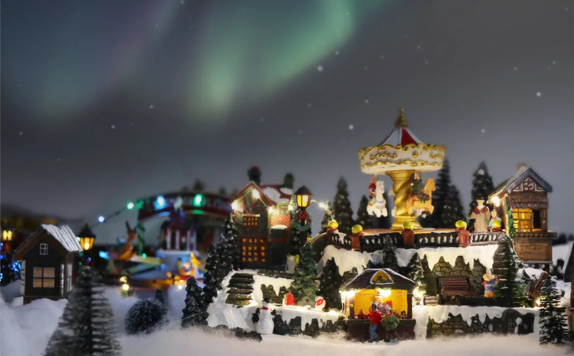 Miniature winter village scene lit up for Julefest
