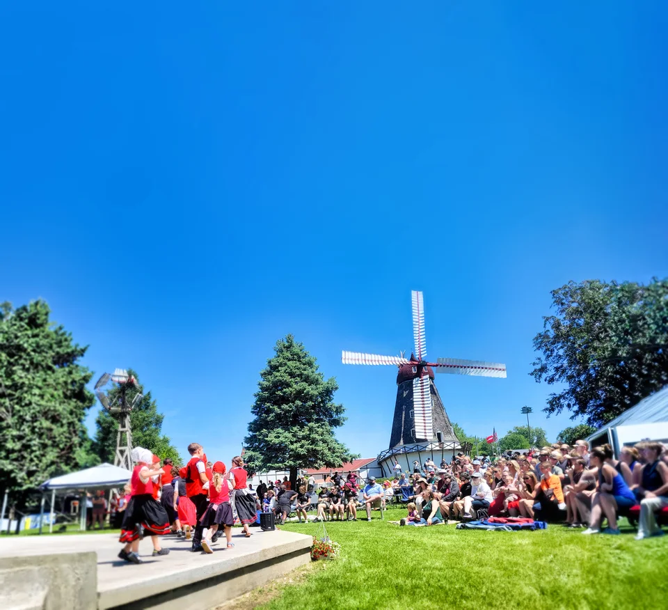 Crowd gathering at Tivoli Fest with the Danish Windmill in the background