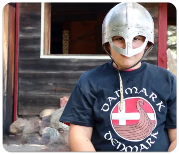 Child wearing a Viking helmet and Denmark shirt
