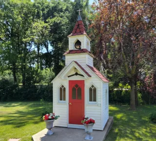 Small white chapel with a red door