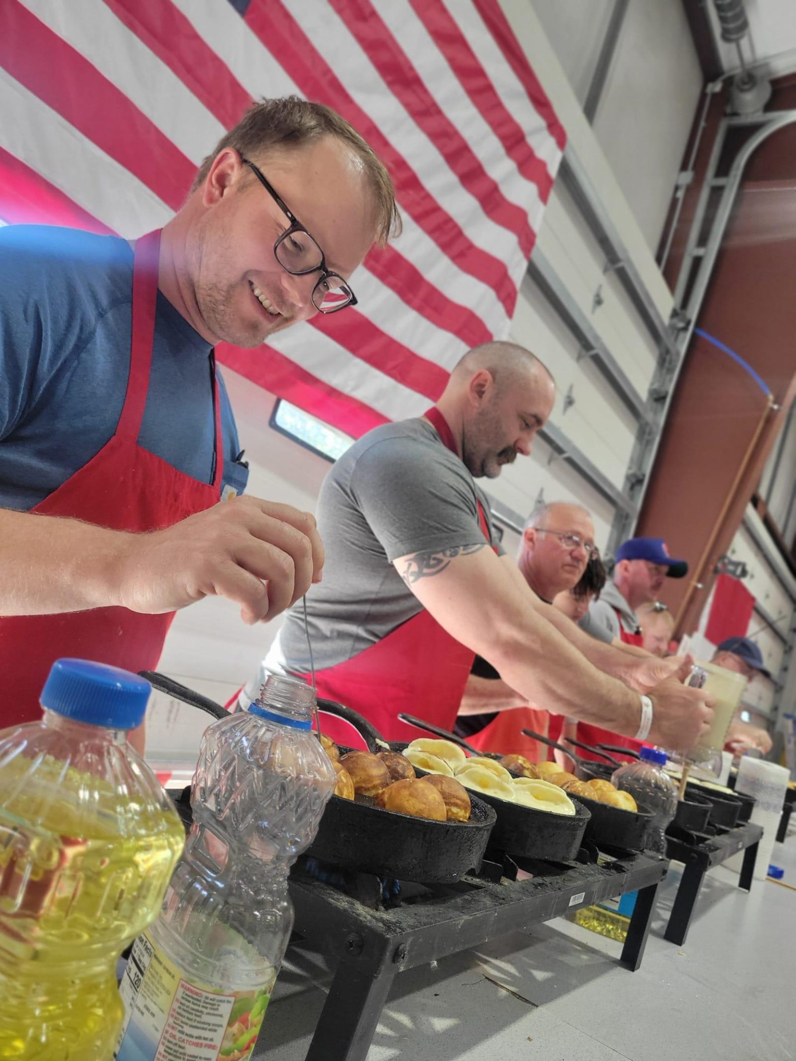 Aebleskiver being prepared or served during a Danish Windmill event.