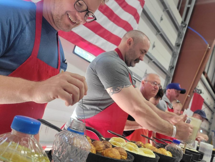Aebleskiver being prepared or served during a Danish Windmill event.
