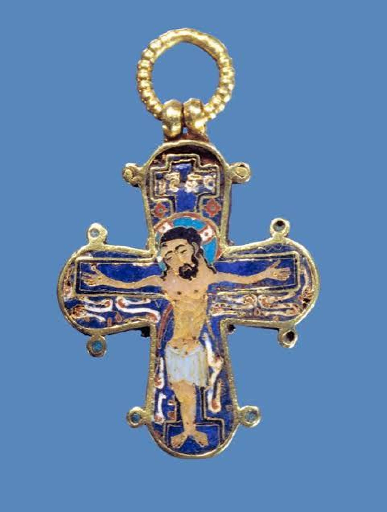 Gold and enamel Dagmar Cross pendant showing Christ on the cross.
